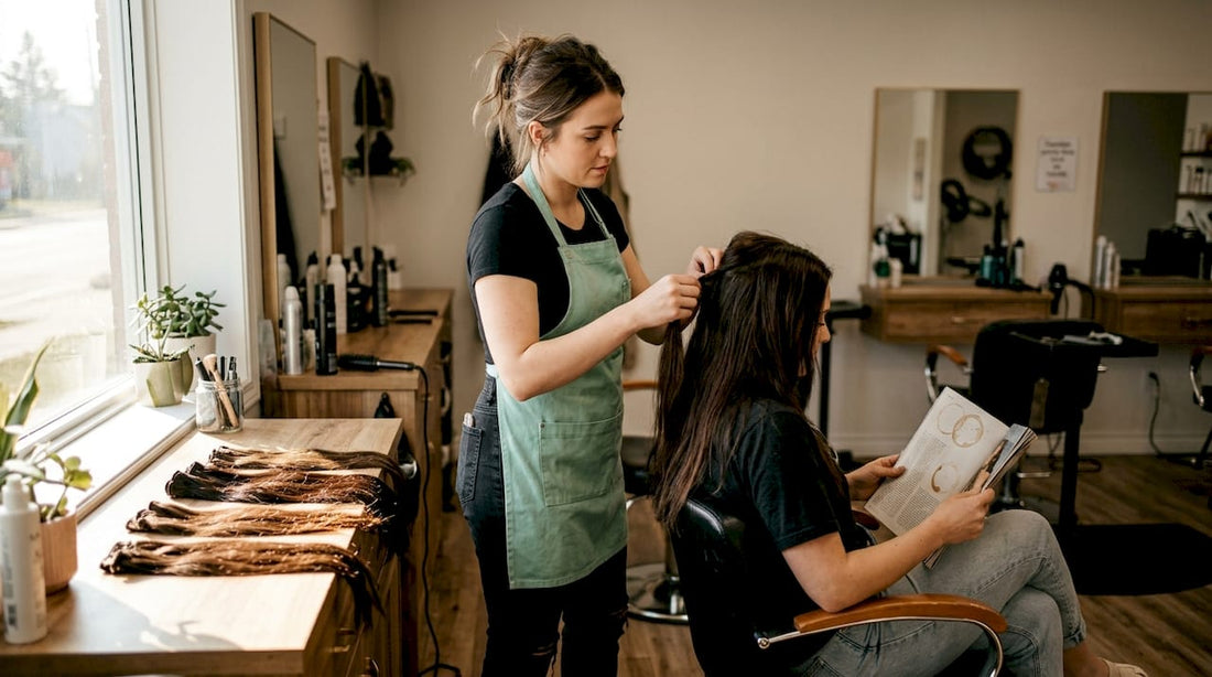 Stylist adjusting natural-looking hair extensions