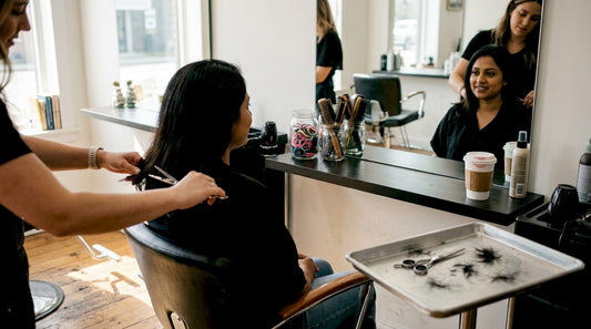 Woman donating hair in a small salon
