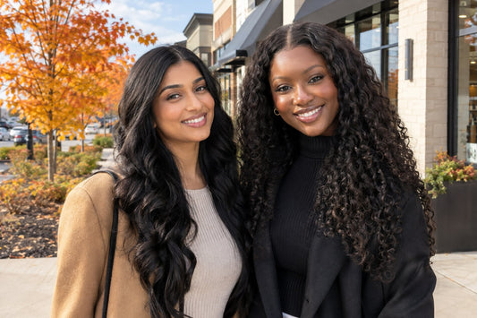 Women with long raw Indian hair extensions outside a Brampton salon in autumn