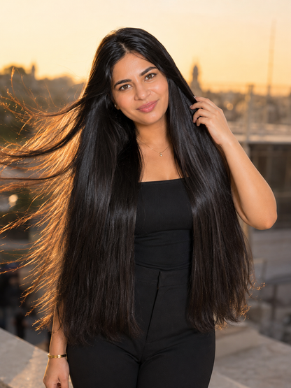 Long dark straight hair worn down by a person, natural shine and smooth texture