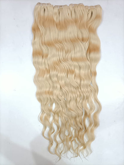 Indian raw 613 blonde hair extensions with wefts from Gaurash Beauty Supply Inc, showing the light blonde, straight hair strands.