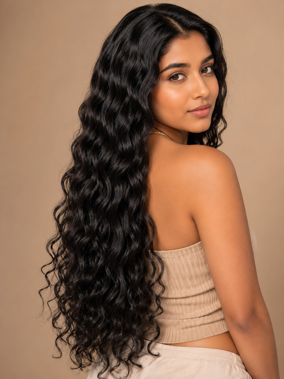 Long black loose curly hair bundle on model, thick curls over shoulder
