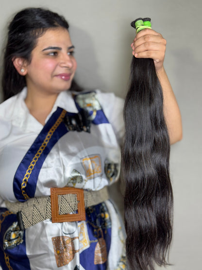 Virgin Indian bulk hair bundles from Gaurash Beauty Supply Inc, soft and natural hair extensions, displayed in a neat pile.