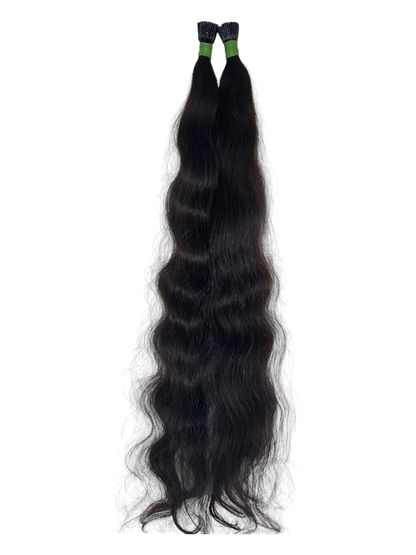 Indian virgin wavy keratin tip hair extensions by Gaurash Beauty Supply Inc, showing long, wavy hair strands with keratin tips.