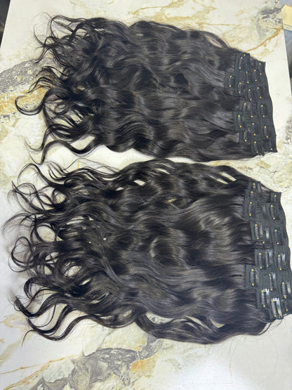 Indian Virgin Wavy Clip-On Hair Extensions by Gaurash Beauty Supply Inc, showing a set of natural wavy hair clips.