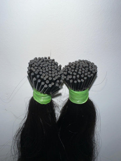 Indian virgin wavy keratin tip hair extensions by Gaurash Beauty Supply Inc, showing close-up of I-tip hair extensions with wavy texture.