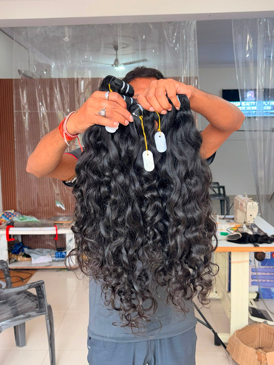 Wavy black human hair extensions bundle with visible three strands and white hang tags