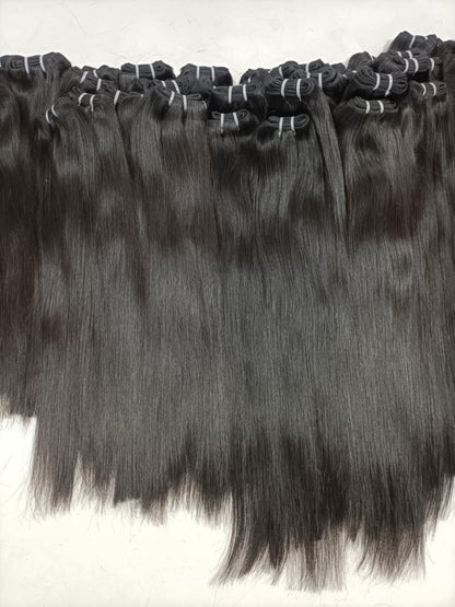 Multiple rows of dark straight hair weft bundles, neatly bound at the top