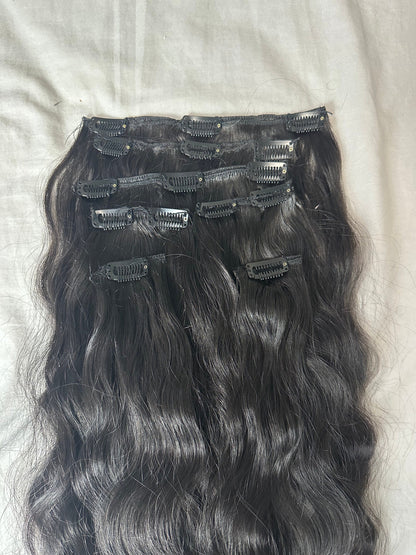 Wavy clip-in human hair extensions in virgin Indian hair, 120g, styled with natural waves, by Gaurash Beauty Supply.