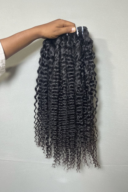 Raw Indian tight curly hair bundles from Gaurash Beauty Supply, steam-enhanced for natural texture and volume.