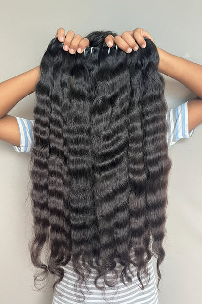 Indian raw curly human hair bundles from Gaurash Beauty Supply, showcasing natural bounce, shine, and unprocessed virgin hair.