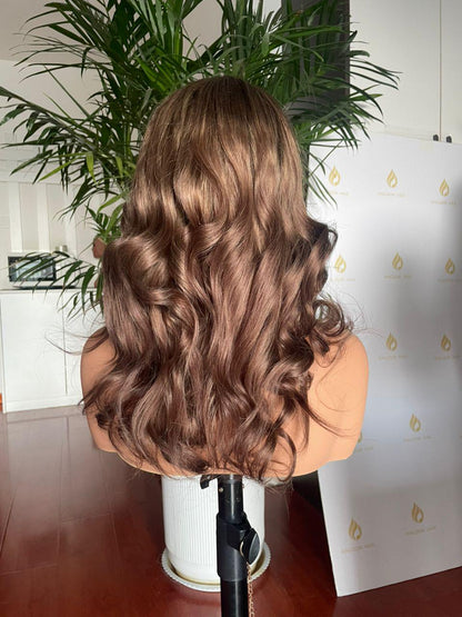 Chocolate brown curly lace front wig made of raw human hair, salon quality, styled with voluminous curls and natural hairline.