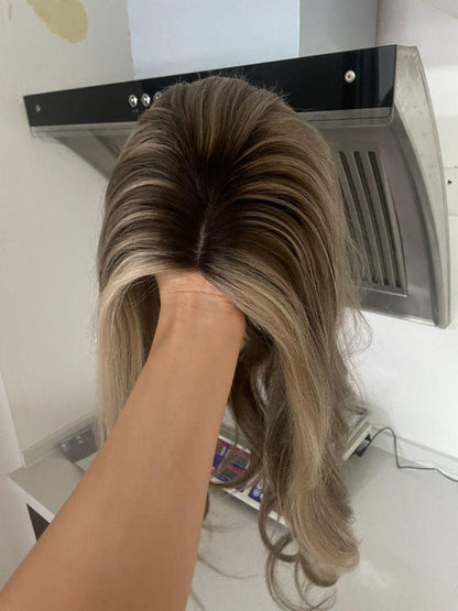 Lace front wig cap with dark roots and blonde wavy hair, top section
