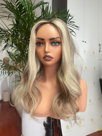 Blonde lace front wig with natural waves, long layered hair on a mannequin
