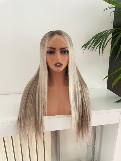 Blonde HD lace front wig made of raw human hair on an adjustable cap, displayed on a mannequin head by Gaurash Beauty Supply.
