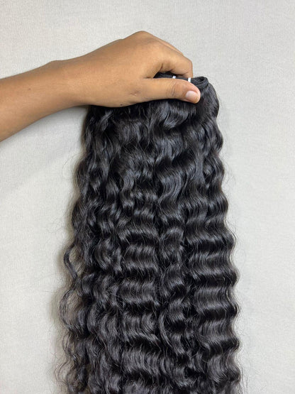 Indian virgin curly human hair bundles from Gaurash Beauty Supply, natural sew-in extensions with voluminous, textured curls.