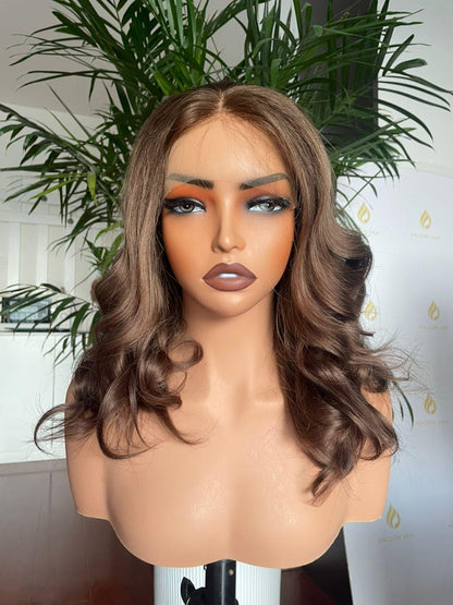 Chocolate brown curly lace front wig made from raw human hair, salon quality, styled with voluminous curls for a natural look.