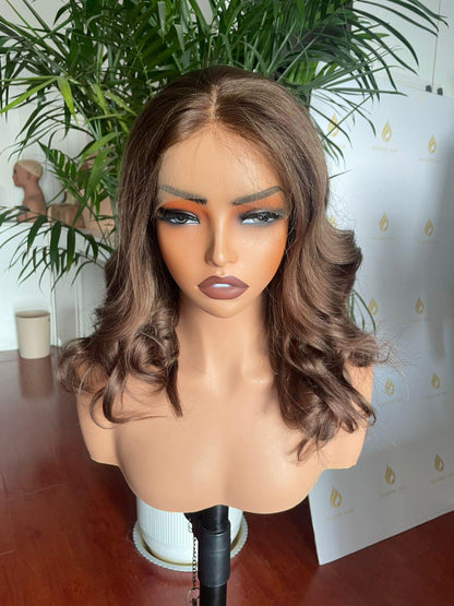 Chocolate brown curly lace front wig made from raw human hair, salon quality, styled with voluminous curls for a natural look.