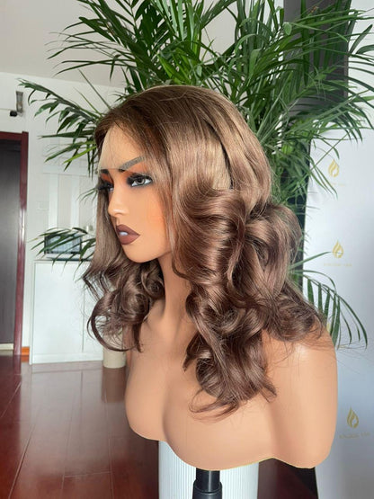 Chocolate brown curly lace front wig made from raw human hair, salon quality, styled with voluminous curls for a natural look.