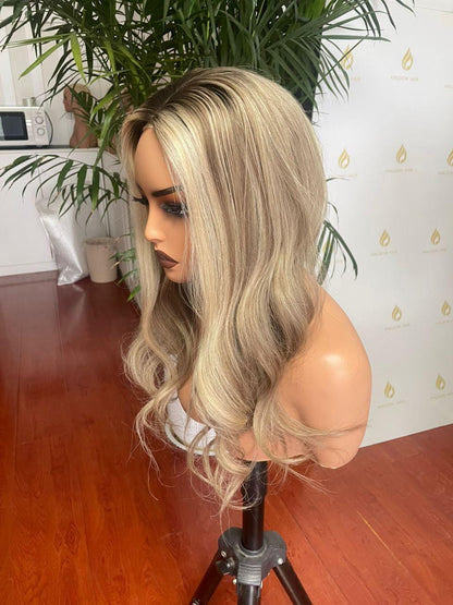 Blonde long wavy lace front wig, side view on a mannequin stand